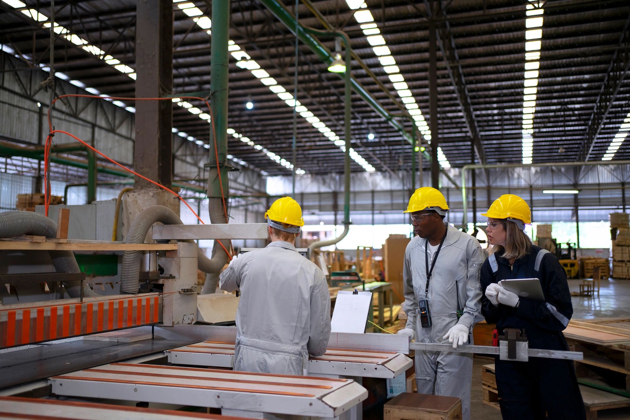 American industrial workers in proper PPE operating within a production facility environment