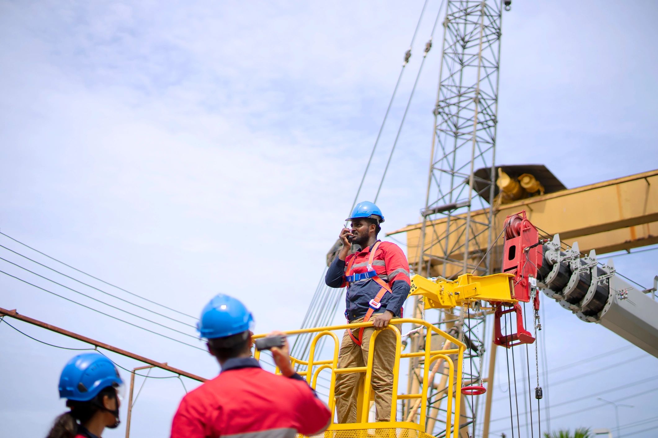 Construction engineers in proper PPE coordinating field work on a large industrial infrastructure project